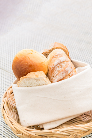 Fresh bread in the basket. Food background.の写真素材