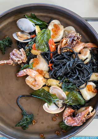 The Mediterranean delicacy food. Black seafood pasta spaghetti  with mussels calm shrimp and crabの写真素材