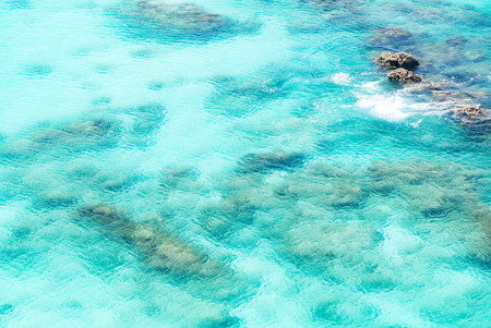 Top view of transparent shallow turquoise ocean sea water surface and rock at andaman sea indian ocean in summer.の写真素材