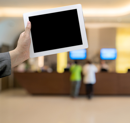 Abstract Blurred background of hotel lobby with digital tabletの写真素材