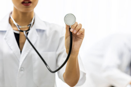Female Doctor holding stethoscope with copyspace