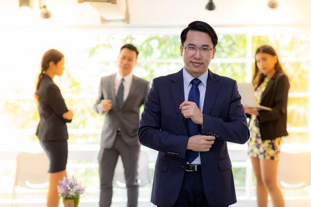 Portrait of Businessman with business teamの写真素材