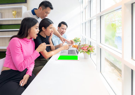 group of Freelance point finger to laptop while thier working in cafe