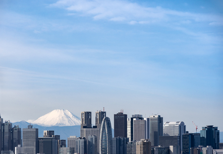 Mountain Fuji with Tokyo skylines and skyscrapers buildings in Shinjuku ward in Tokyo. Taken from Tokyo Bunkyo civic center observatory sky desk.の写真素材