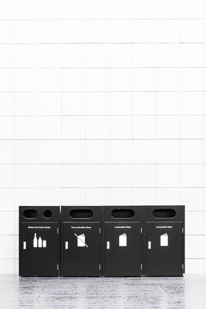 Recycle bins for rubbish, recycling and garden waste, over white wall backgroundの写真素材