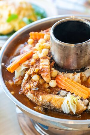Sour curry soup with fried fish and seafood fish egg with mix vegatable, traditional thai food cuisineの写真素材