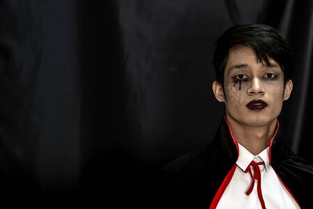 Portrait of teenager boy in Halloween costume for Halloween party backgroundの写真素材