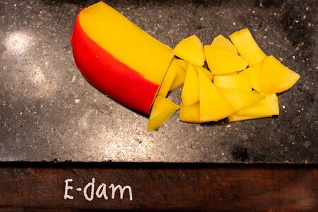 edam cheese on black stone plate in buffet lineの写真素材