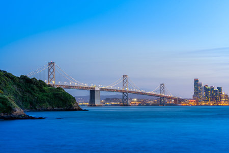 Beautiful sunset with Bay bridge and San Francisco Bay landscape in North California USA West Coast...