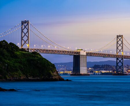 Beautiful sunset with Bay bridge and San Francisco Bay landscape in North California USA West Coast of Pacific Ocean, San Francisco United States Landmark Travel Destination cityscape concept.の写真素材