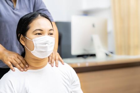 Quarantine asian woman do massage at home while city lockdown for social distance due to coronavirus pandemic. Massage and spa is one of service business that shutdown while city lockdown.の写真素材