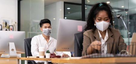 Panorama asian Office employee with protective face mask working in new normal office with social...