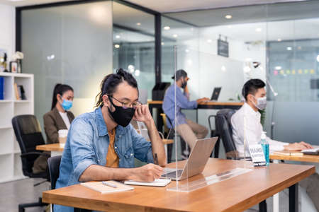 Group of interracial business worker team wear protective face mask in new normal officeの写真素材