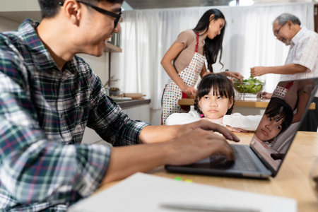 Asian upset girl looking and waiting her father working from home while city lockdown in dining room...