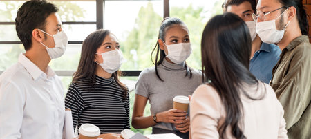 Panoramic web banner crop. Group of business worker team meeting and brainstorm for startup new business. They wear protective face mask in new normal office preventing coronavirus COVID-19 spreading.の写真素材