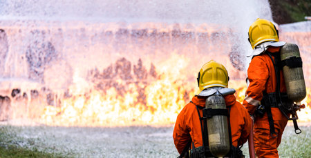 Panoramic Firefighter using Chemical foam fire extinguisher to fighting with the fire flame from oil...