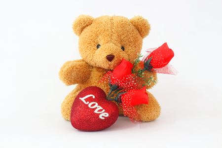 Brown teddy bears and red roses on a white background.の写真素材