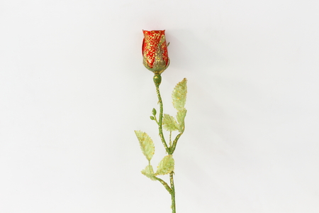 Plastic red roses on a white background.の写真素材