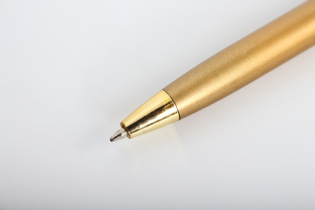 Golden pen on a white background.の写真素材