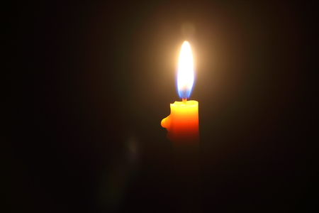Lighting candles on a black background.の写真素材