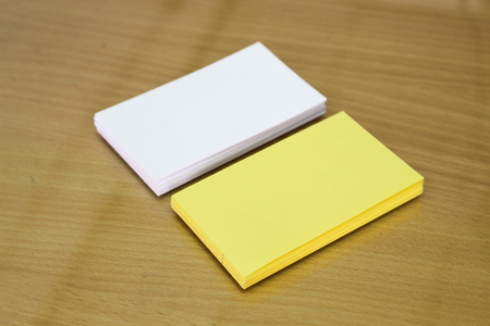White and yellow card on the desk.の写真素材