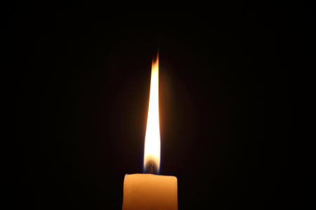Lighting candles on a black background.の写真素材