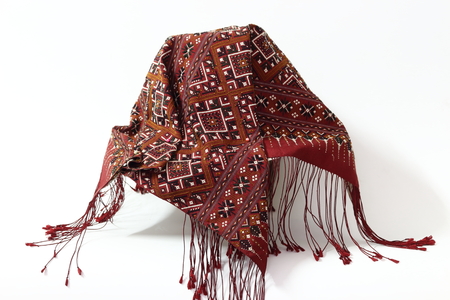 Thailand silk hat decorated with red on a white background.の写真素材
