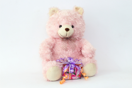 Pink teddy bear and gift boxes on a white background.の写真素材