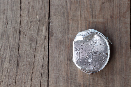 Lovely coin pouch placed on a wooden background.の写真素材