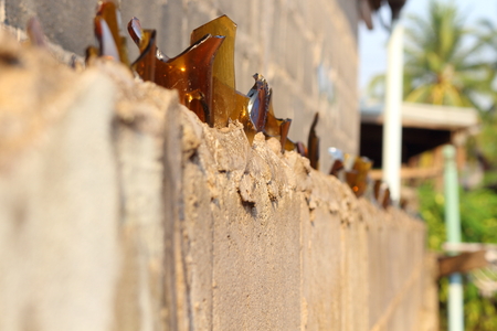 Brown glass fragments arranged on the wall.の写真素材