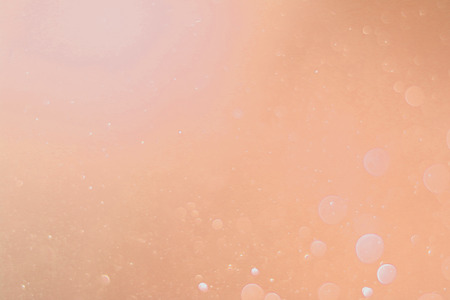 A beautiful and blurry bokeh on an orange background.の写真素材