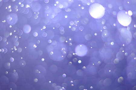 A beautiful and blurry bokeh on a blue background.の写真素材