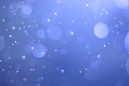 A beautiful and blurry bokeh on a blue background.の写真素材