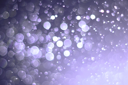 A beautiful and blurry bokeh on a purple background.の写真素材