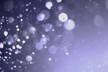 A beautiful and blurry bokeh on a purple background.の写真素材