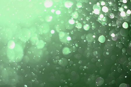 Beautiful and blurry bokeh on a green background.の写真素材