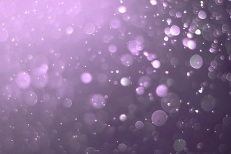 A beautiful and blurry bokeh on a purple background.の写真素材