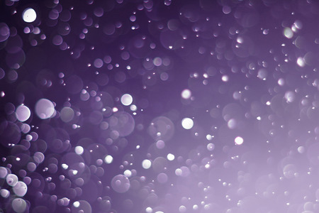 A beautiful and blurry bokeh on a purple background.の写真素材