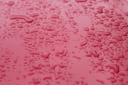 Drops on red background.の写真素材