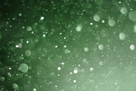 Beautiful and blurry bokeh on a green background.の写真素材