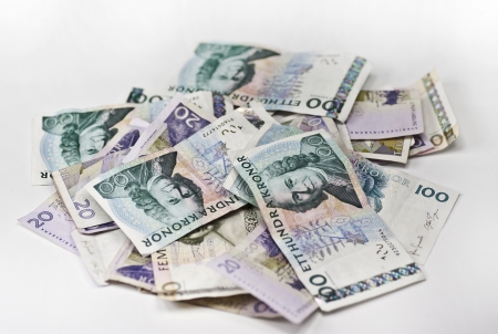 A heap of swedish currency on white backgroundの写真素材