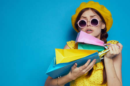 cheerful woman wearing sunglasses posing shopping fashion isolated backgroundの写真素材