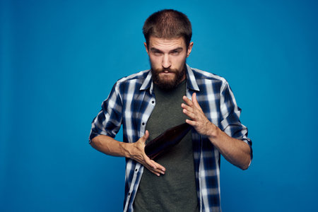 a man in a plaid shirt drinking beer alcohol emotion isolated backgroundの写真素材