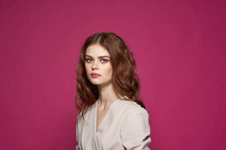 portrait of a woman bright makeup attractive look a bouquet of fruits pink backgroundの写真素材