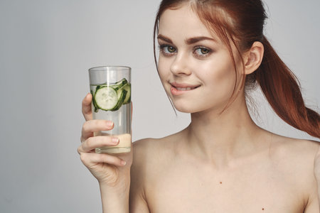 woman with cucumber drink health vitamins close-up