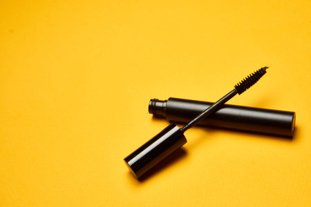 cosmetics mascara brushes decoration accessories yellow background