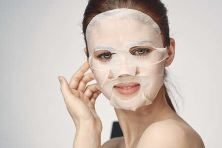 woman in cosmetic mask facial skin care rejuvenationの写真素材