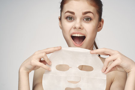 woman with mask in hands skin care rejuvenation spa treatments