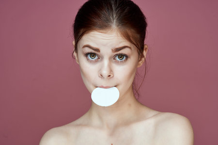 woman with bare shoulders cotton pads pure skin charm pink background