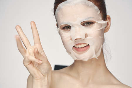 pretty woman naked shoulders face mask close-up skin careの写真素材